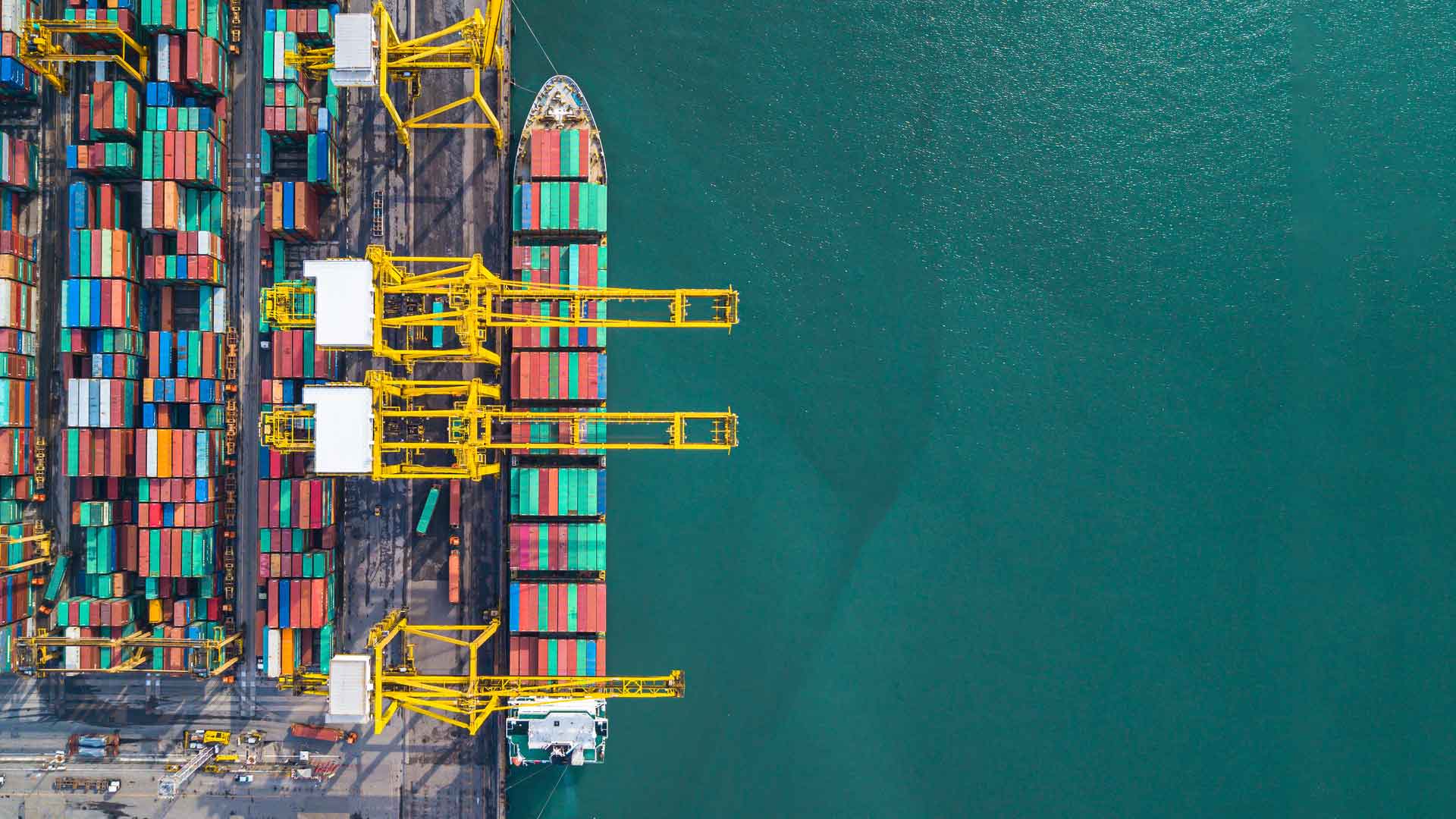 aerial view of ship being loaded with colorful containers
