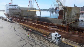 The project logistics needed to move a shipment of large pilings from truck to ship to its destination