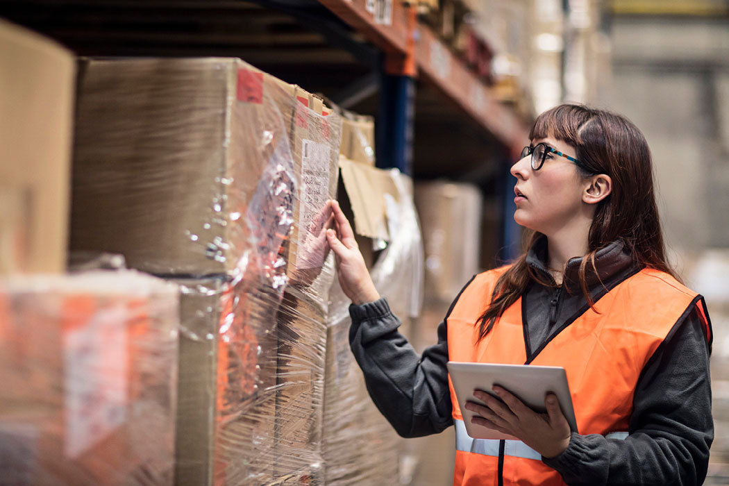 Reverse logistics: Woman on a loading dock with ipad