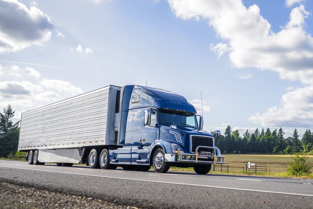 Freight truck driving down the road