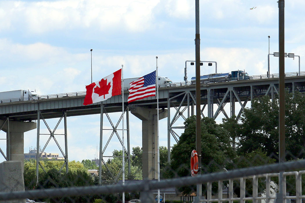 Canadian and U.S. flags flying at northern border crossing