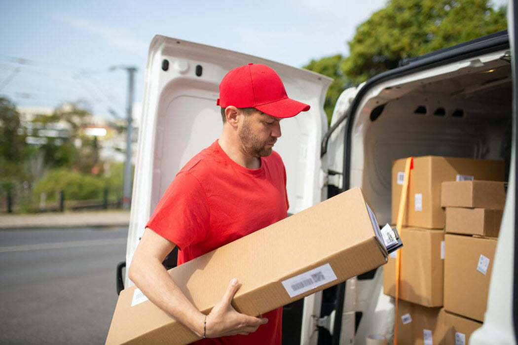 Expedited shipping driver unloading package from van