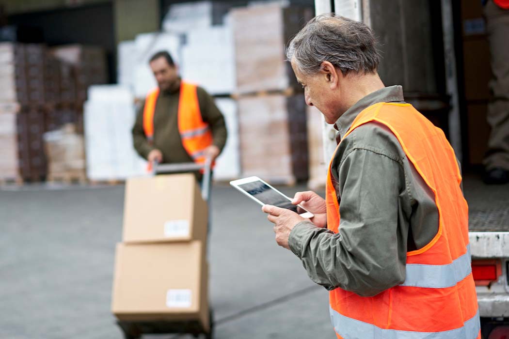 Man looking at TMS technology on LTL loading dock
