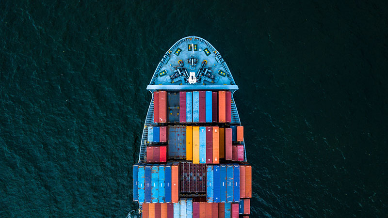 aerial view of the front end of a container ship at sea