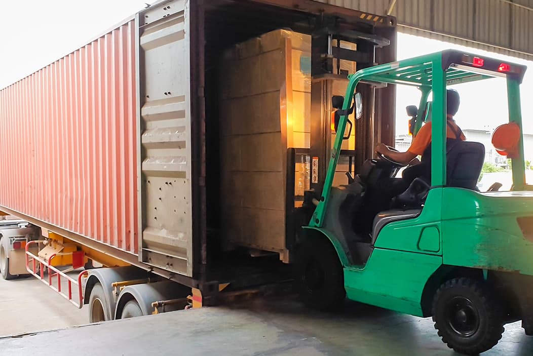 Semi trailer being loaded with a fork lift at a retail warehouse