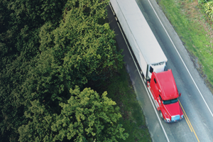 Ariel view of semi truck next to forest