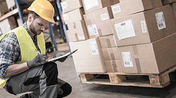 worker-checking-shipment-status-on-freight