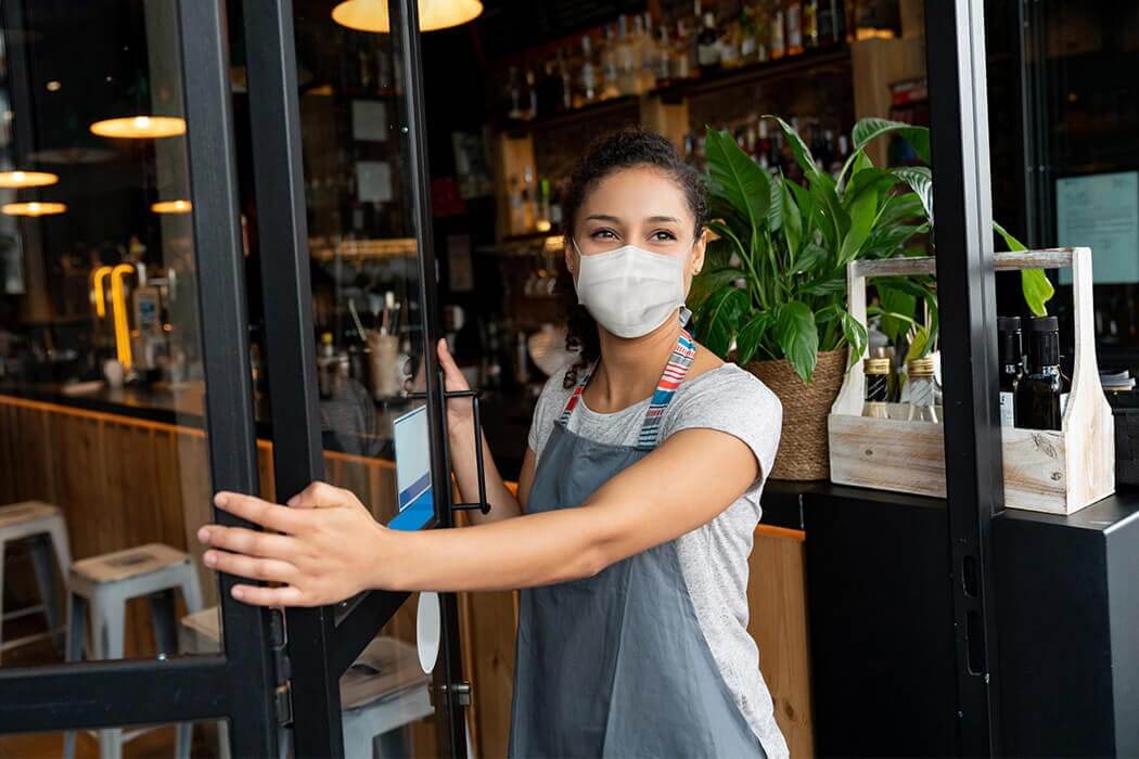 Woman in a mask at a restaurant 