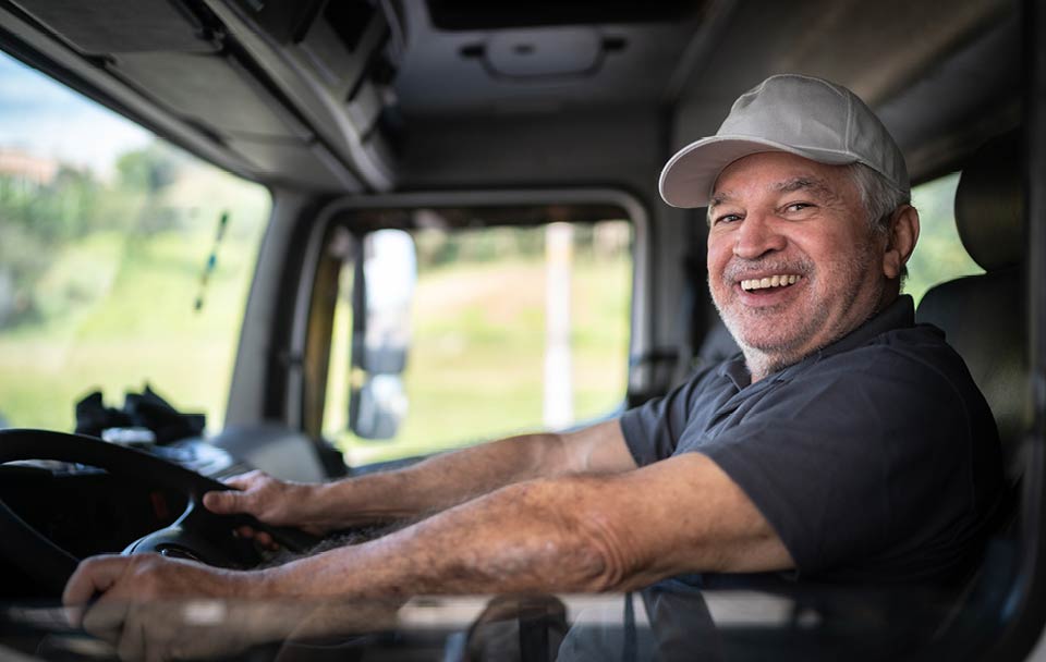 Male truck driver smiling at the camera