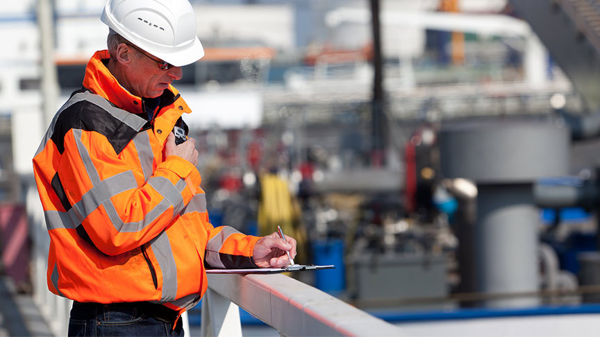 Port worker making notes on a tablet