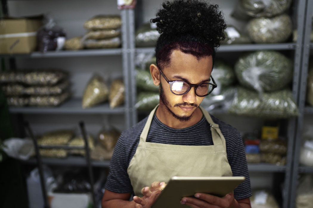 Food services employee looking down at tablet